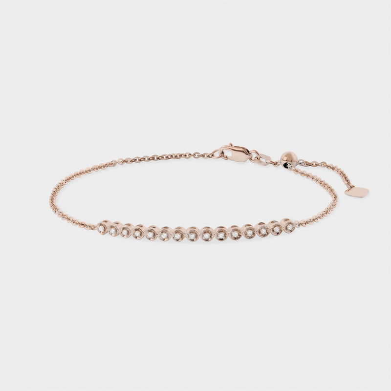 Rose gold bracelet with colorless diamond on a light gray background