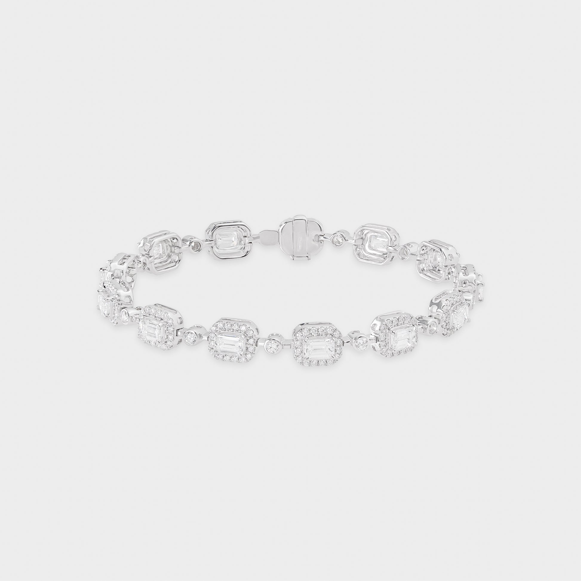 White gold bracelet with clear emerald-shaped diamond on a light gray background