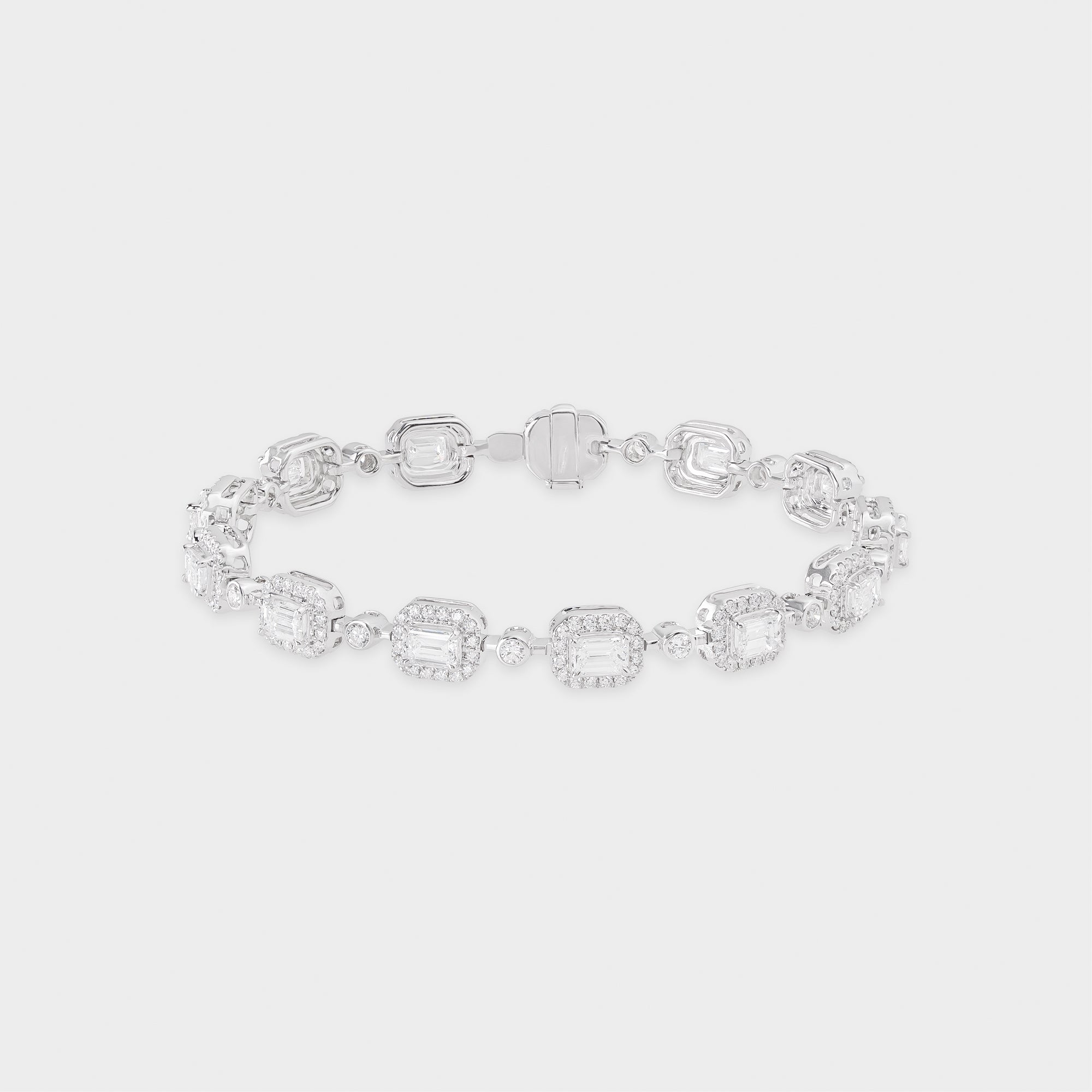 White gold bracelet with clear emerald-shaped diamond on a light gray background
