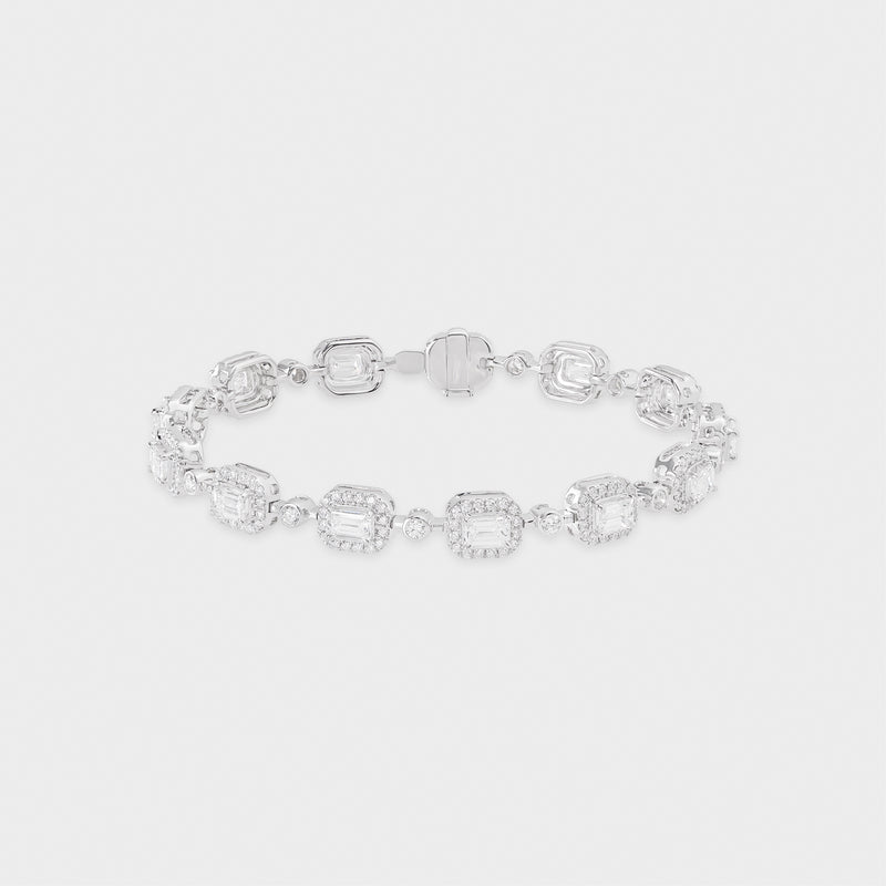 White gold bracelet with clear emerald-shaped diamond on a light gray background