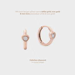 Rose gold earring with colorless diamond on a light gray background