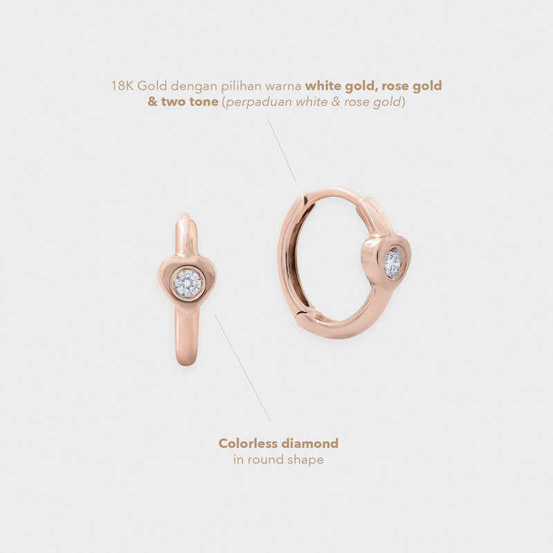 Rose gold earring with colorless diamond on a light gray background