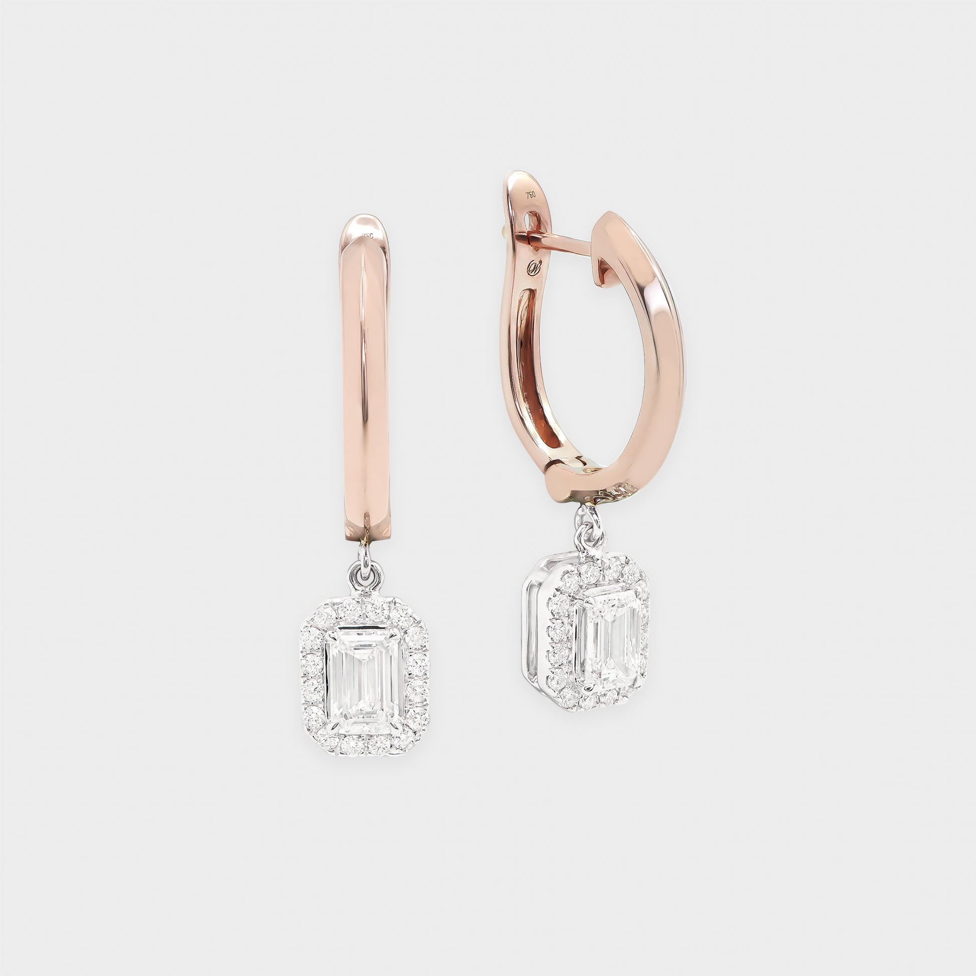 Rose gold hoop earrings with diamond drop pendants on a light gray background