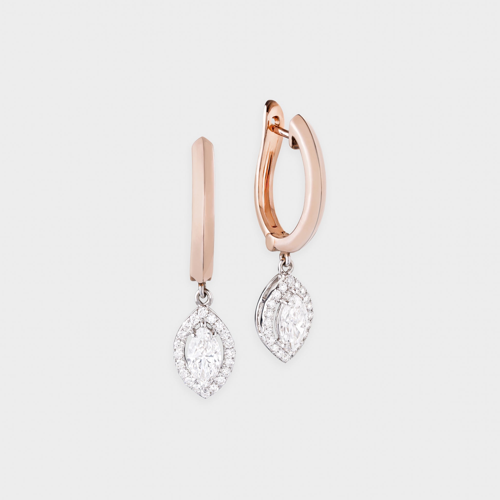 Rose gold hoop earrings with diamond drop pendants on a light gray background