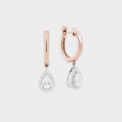 Rose gold hoop earrings with teardrop-shaped diamond drops on a light gray background