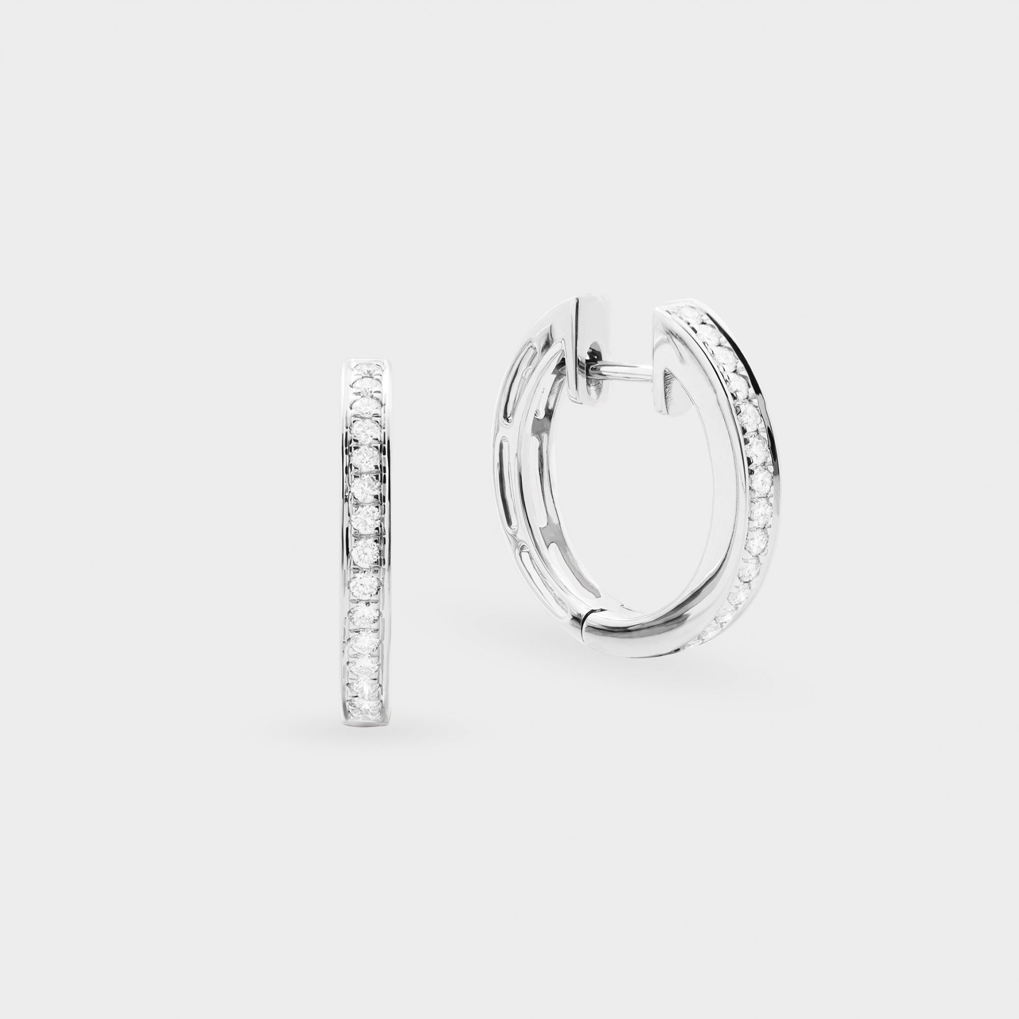 White gold hoop earrings with embedded stones on a light gray background