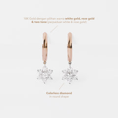 Rose gold hoop earrings with diamond snowflake pendants on a light gray background