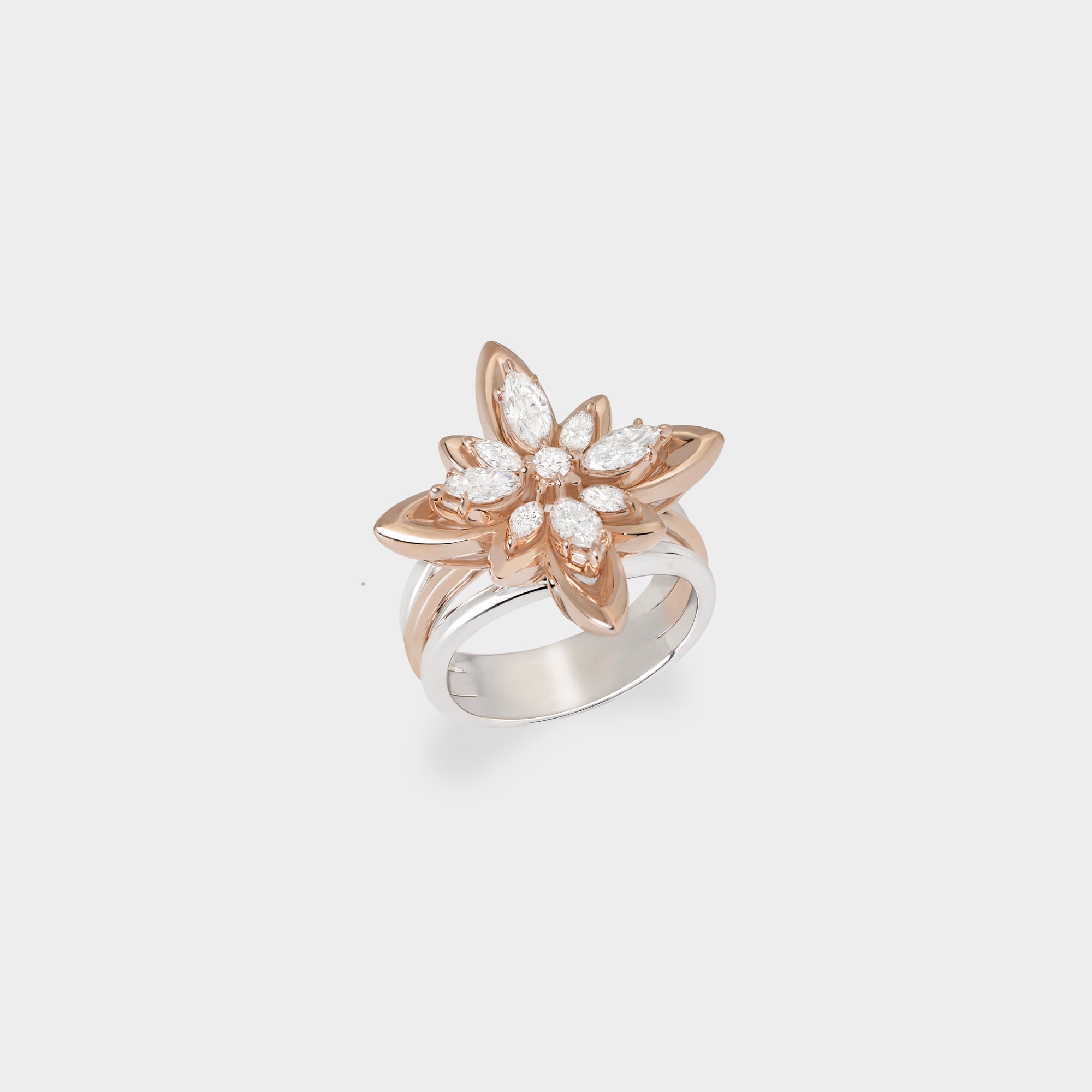 Rose and white gold ring with floral design on a light gray background