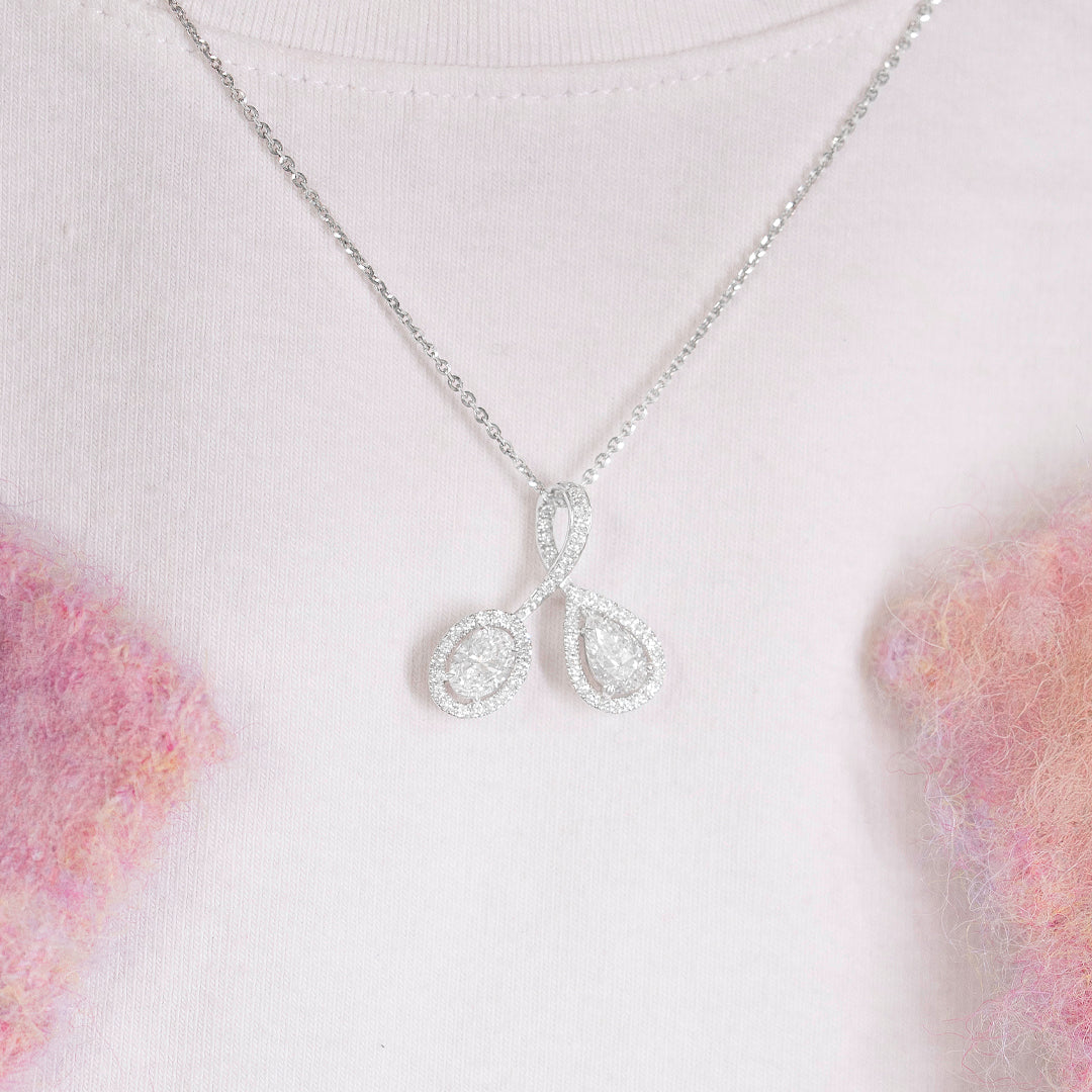 White gold necklace with a oval and teardrop-shaped pendant on a white background